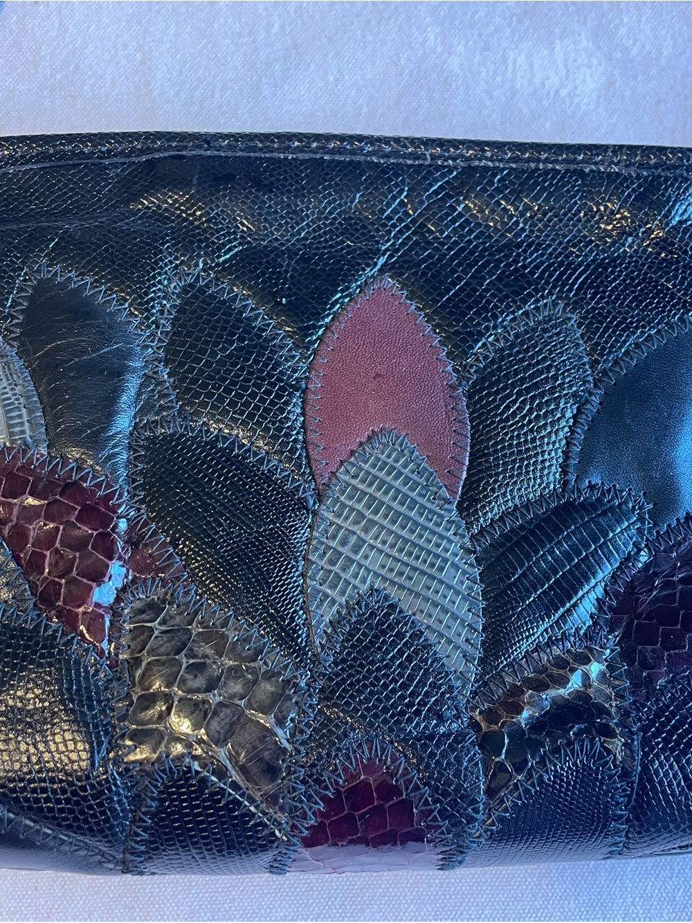 Textured Black Patchwork Leather Clutch with Burgundy Accents